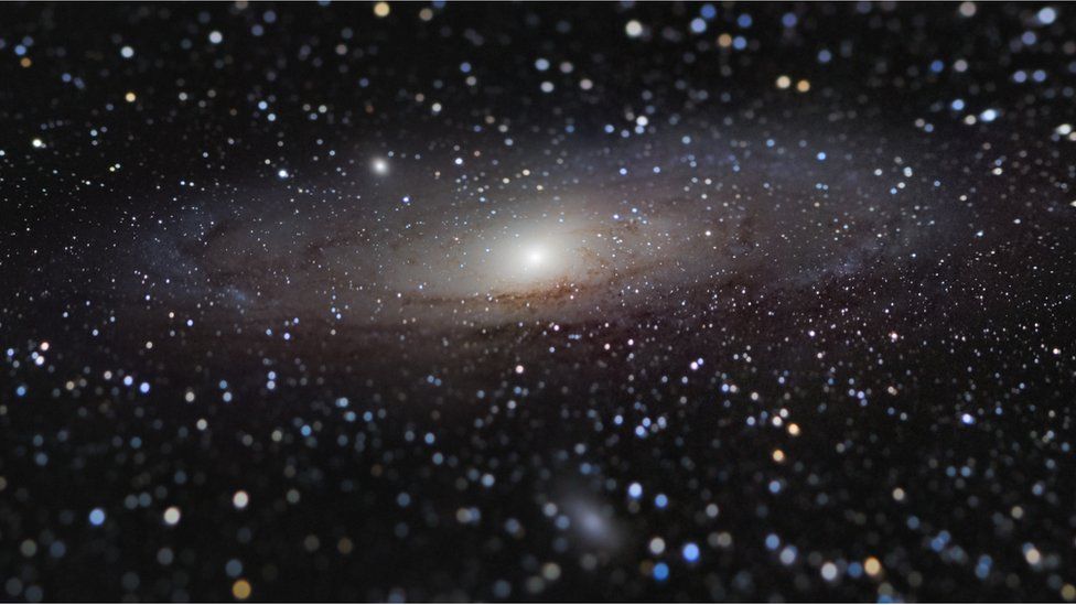 A photo of Andromeda galaxy with a tilt shift effect making the galaxy appear close