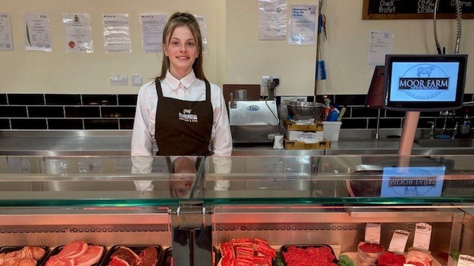 Lottie Mallia behind the butcher's counter