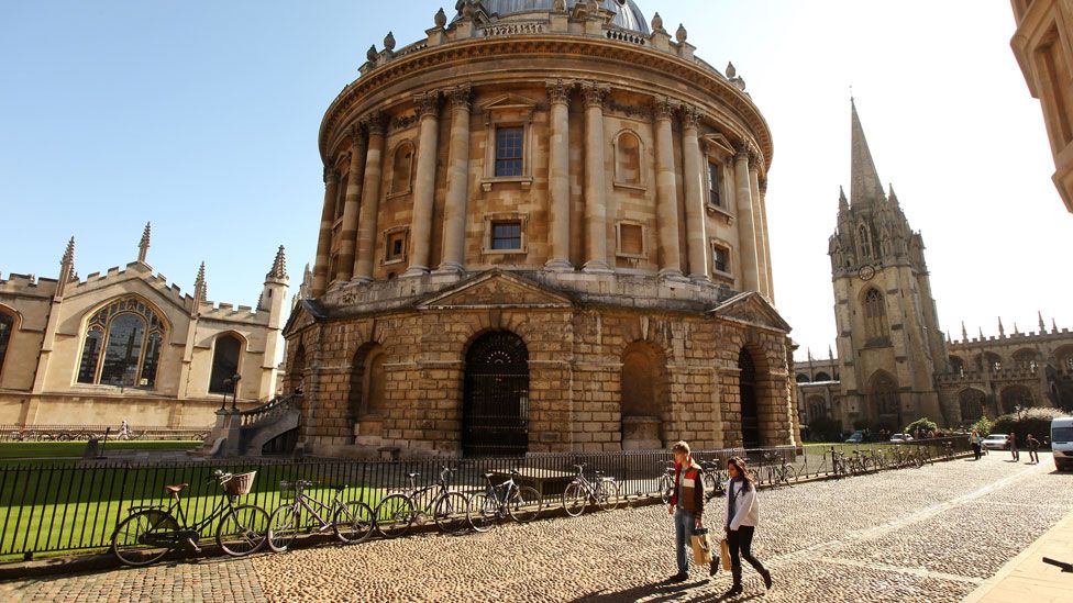 People walking past a building at University of Oxford
