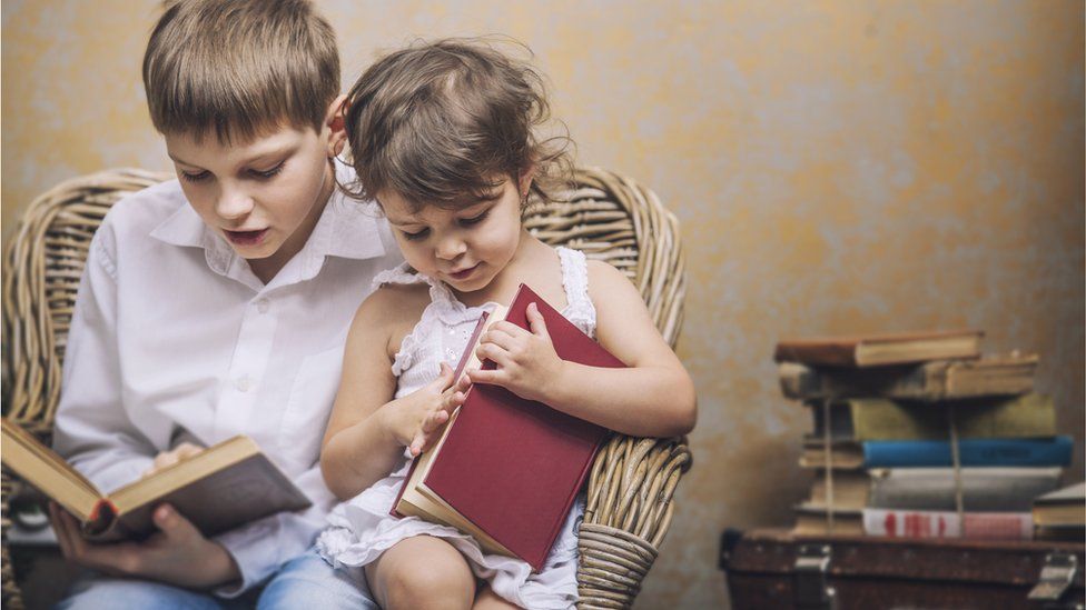 Two children reading books