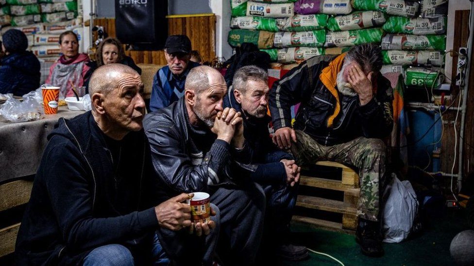 People sit in a humanitarian aid centre in Bakhmut, Ukraine