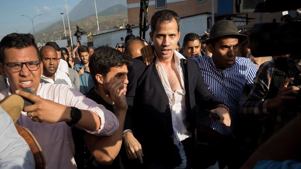 Guaidó at an airport near Caracas, having had his shirt ripped open by protesters