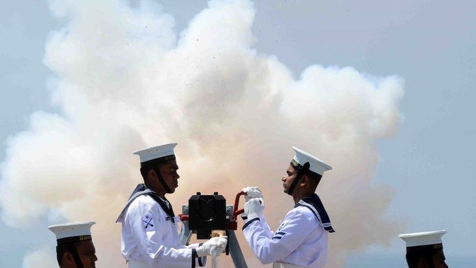 Sri Lankan navy personnel fire a gun to mark independence day