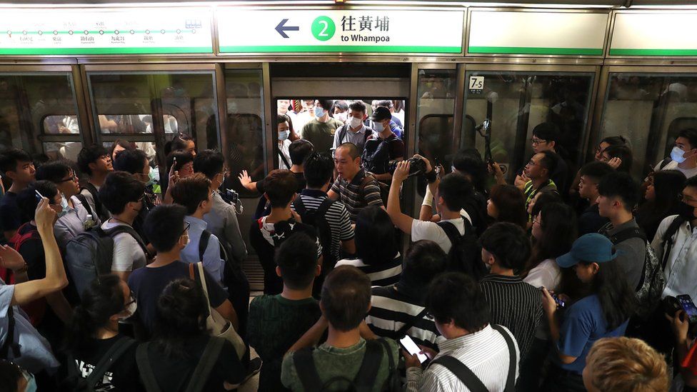 Train passengers wait as Anti-extradition bill protesters disrupt train services