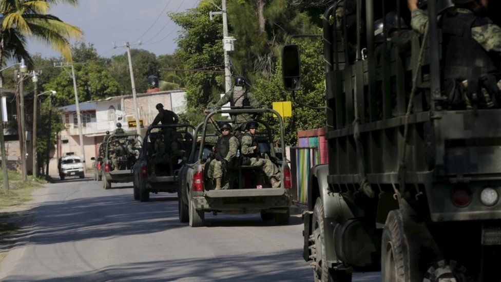 A military convoy patrols the town of Cocula, on the outskirts of Iguala,