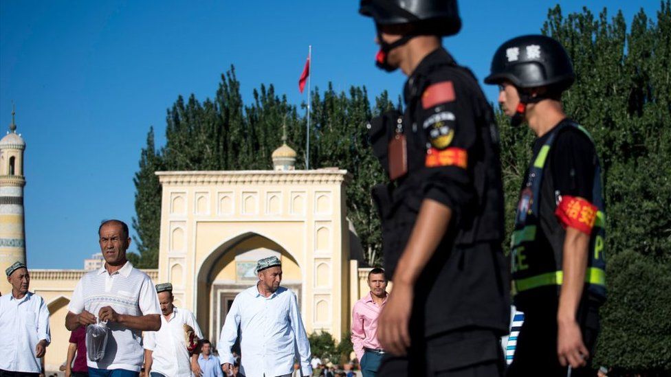 Police patrolling as Muslims leave the Id Kah Mosque in the old town of Kashgar in China's Xinjiang