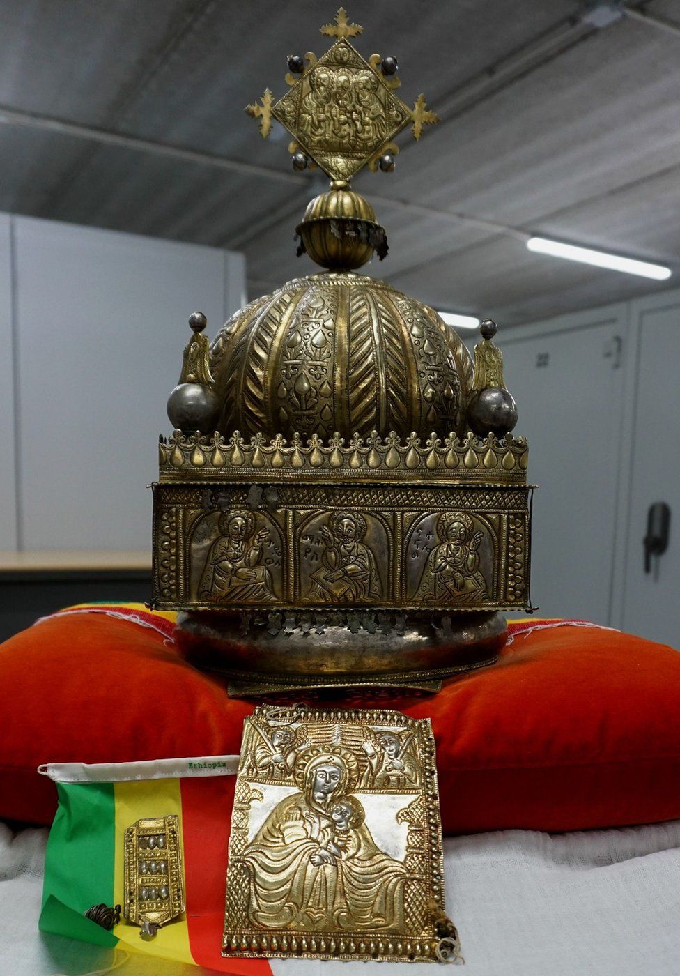 The crown in its secure storage facility, sat on a red pillow with an Ethiopian flag beside it