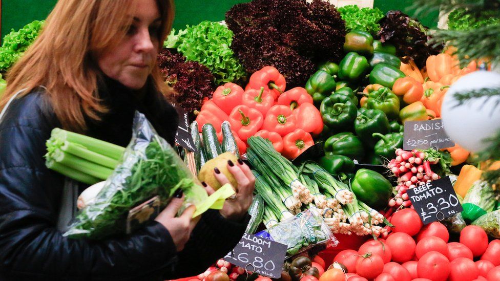 Woman buying vegetables at a market