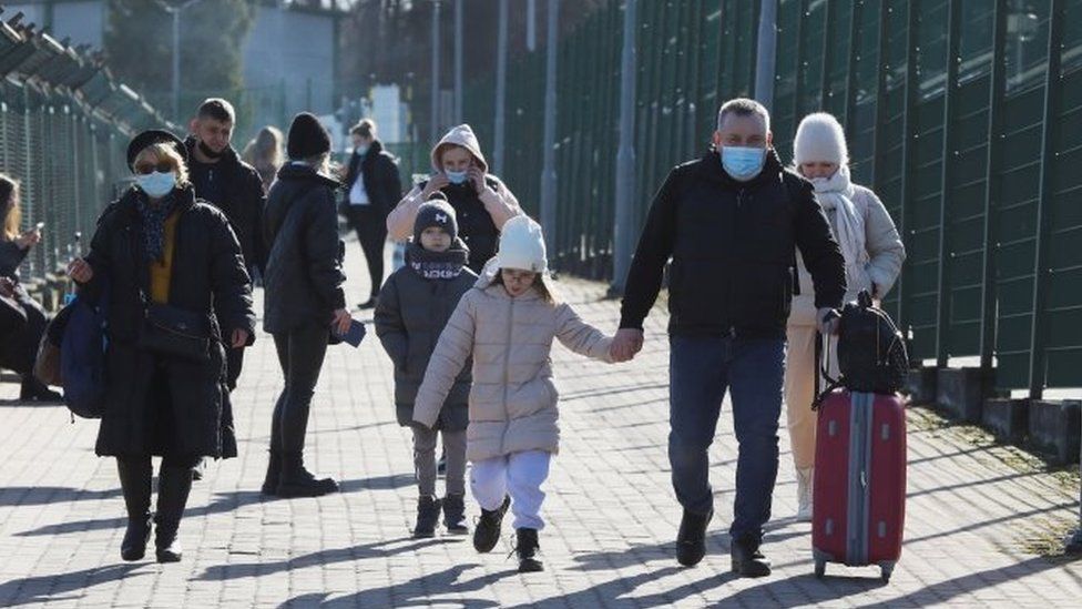 People walk at the border crossing between Poland and Ukraine
