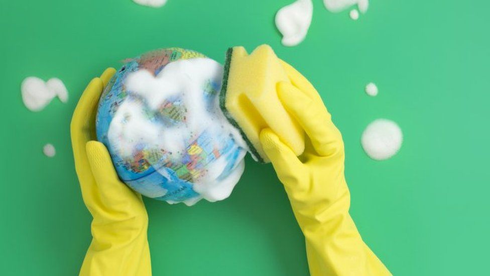 rubber-gloves-washing-a-mini-globe