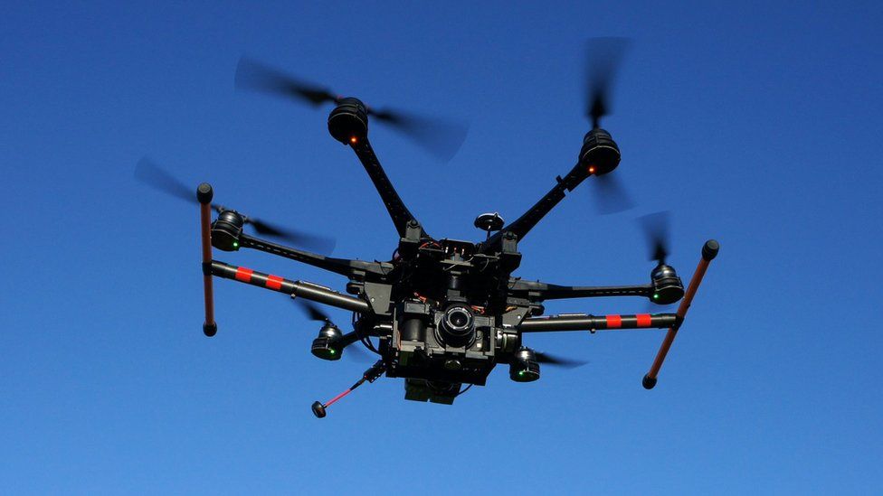 Large drone with camera in flight
