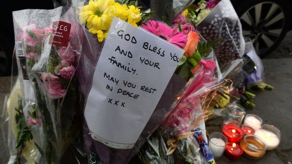 Flowers left in tribute after a shop worker was murdered in January