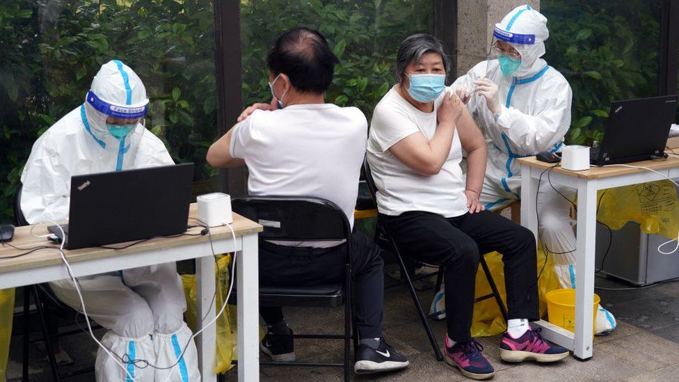 Elderly people receive a dose of COVID-19 vaccine at a residential community on May 26, 2022 in Shanghai, China.