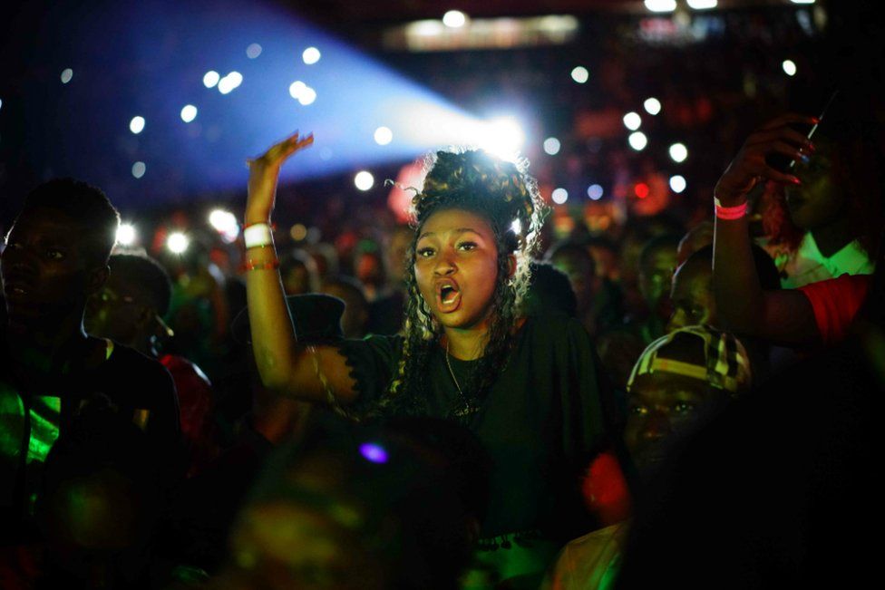 A woman sings during the concert of Malian musician Sidiki Diabate at Modibo Keita Stadium in Bamako on September 3, 2017. Diabate is one of the most popular Afro Trap singers in Mali and Africa. He also plays the kora and contributed to the album Lamomali with Matthieu Chedid and his father renowned kora player Toumani Diabate.