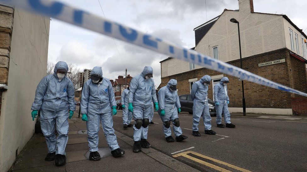 Forensic officers searching the streets