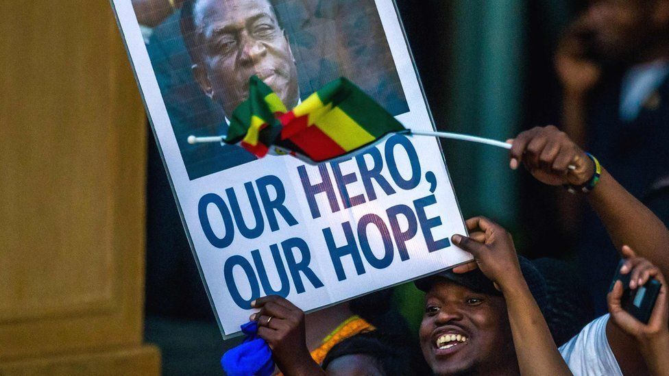 Supporters of Emmerson Mnangagwa in Zimbabwe hold a banner, saying "Our hero, our hope" - Harare, 22 November 2017