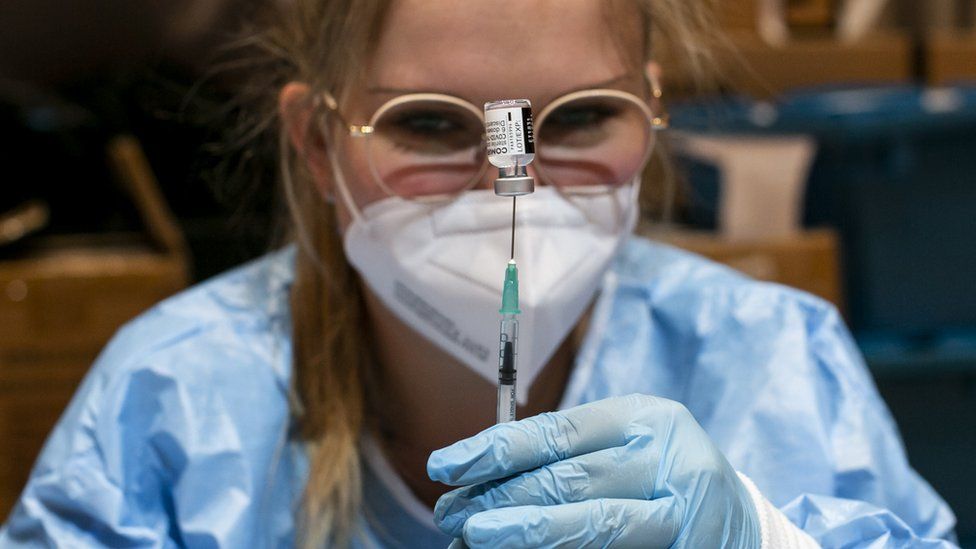 A nurse fills syringes with the Pfizer-BioNTech vaccine during a mass vaccination drive at SZentrum on 11 March 2021