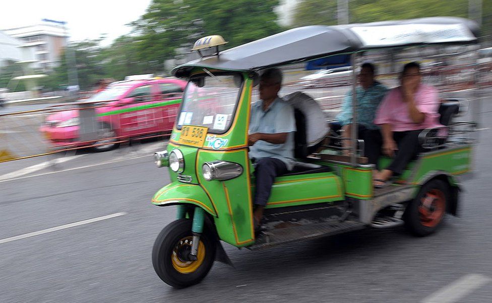 Passengers are transported on a 'Tuk-tuk' at the central Bangkok on 20 January 2010.