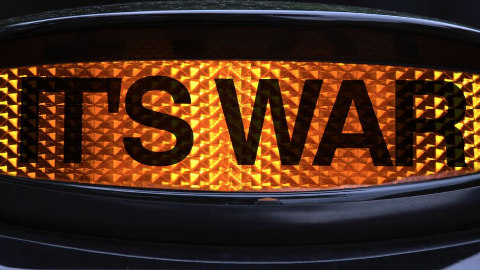 Taxi sign with words "It's War" replacing the word taxi