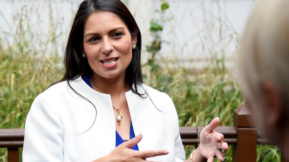 Britain's Home Secretary Priti Patel gestures as she speaks during a visit to the West Midlands Police Learning Development Centre in Birmingham