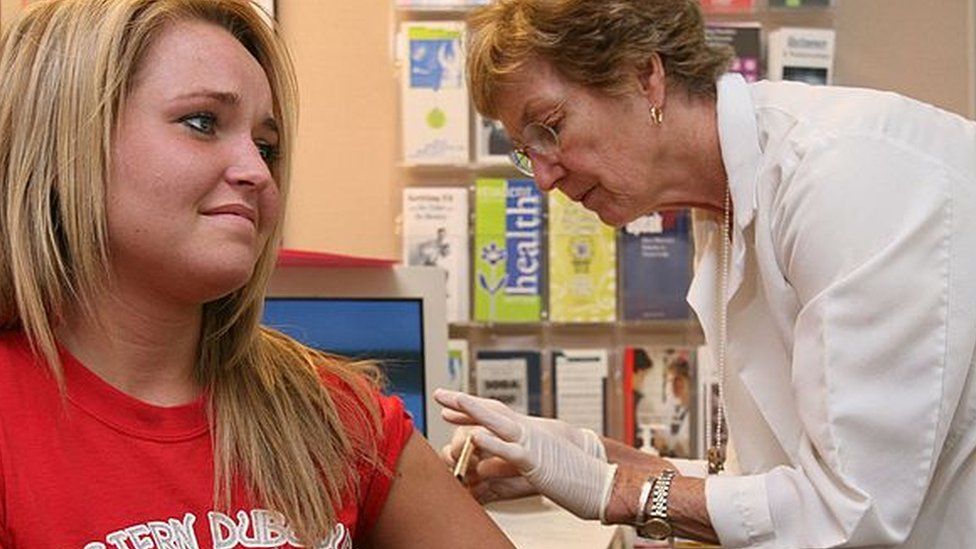 young woman receives MMR injection
