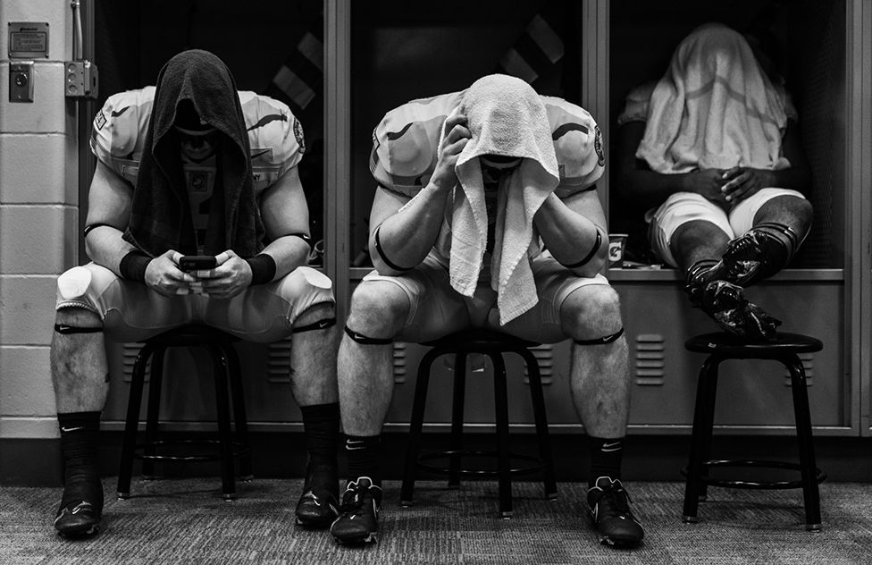 Wilson Catoe, Cade Barnard, and Jakobi Buchanon of the Army Black Knights sit in the locker room before a game against the Navy Midshipmen at MetLife Stadium inn East Rutherford, New Jersey, 11 December 2021,