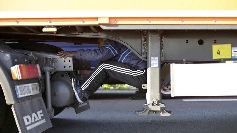 A migrant hiding in the underside of a lorry