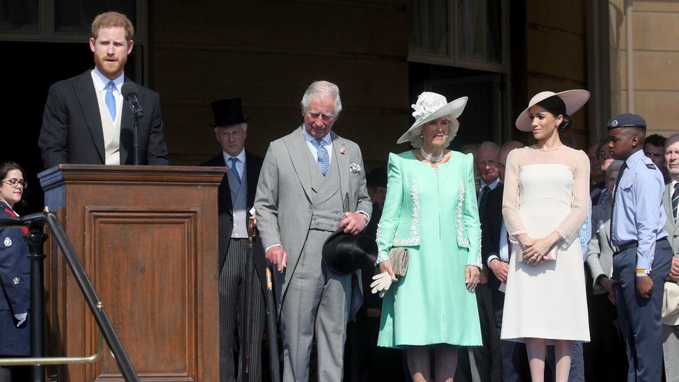 Prince Harry took to the podium to make a speech as his wife, father and the Duchess of Cornwall looked on