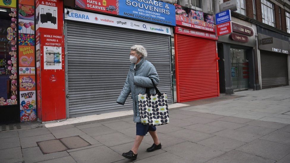 A woman walking down an empty street in London