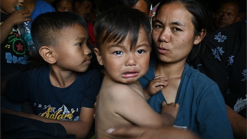 People are evacuated by the Indian army to a temporary shelter as they flee ethnic violence that has hit the northeastern Indian state of Manipur, near Imphal on May 7, 2023.