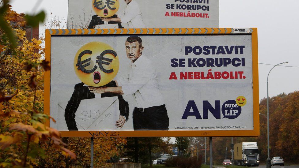 Cars drive past election campaign posters of the leader of ANO party Andrej Babis in Prague. The poster reads: "Stand up against corruption and stop babbling"
