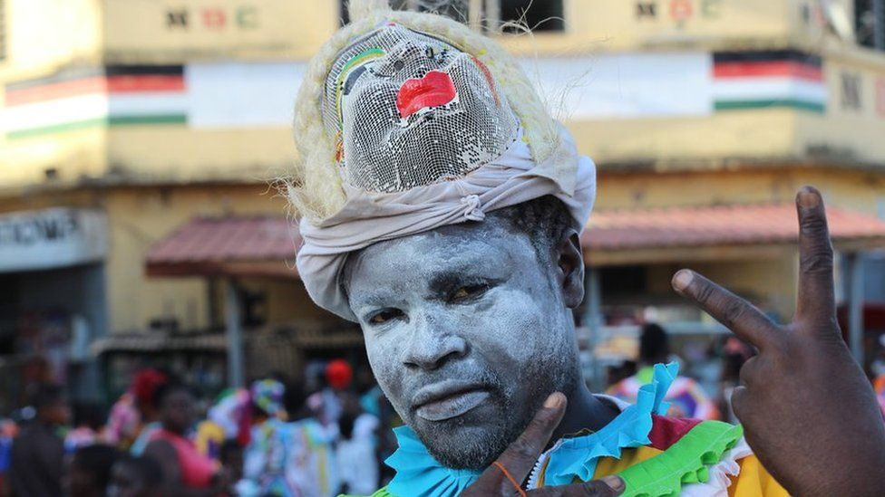 Man with face whitened by talcum powder in Sekondi Ghana