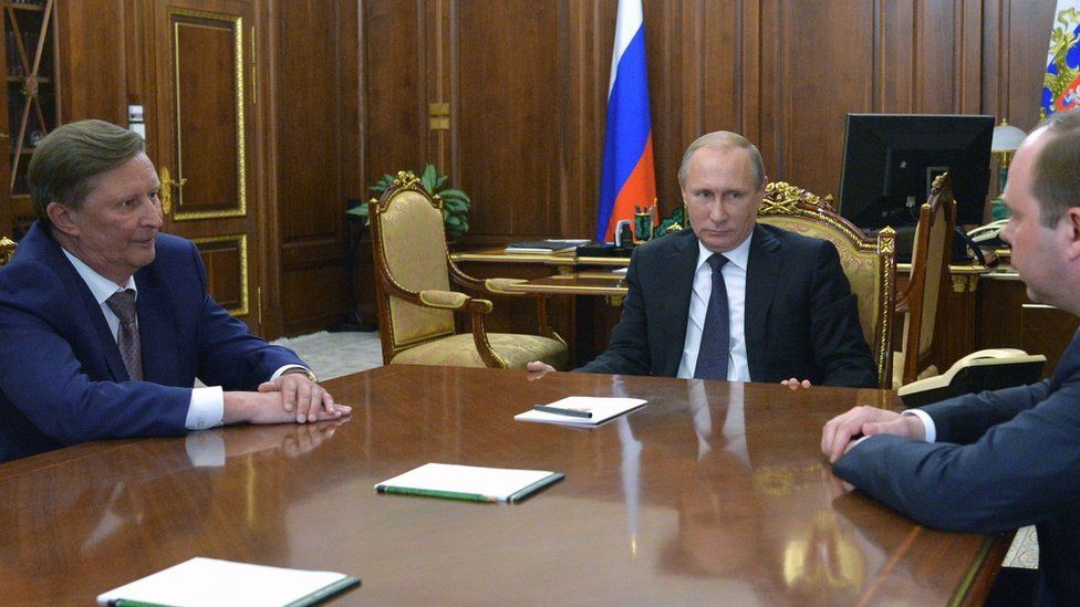 Russian President Vladimir Putin (C) speaks with the newly-appointed Chief of Staff of the Presidential Executive Office Anton Vaino (R) and the newly-appointed Presidential Representative for Environmental Management, Ecology and Transport Sergei Ivanov (L)