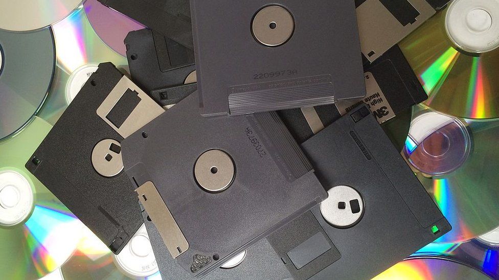 Generic shot of a pile of floppy disks and CDs