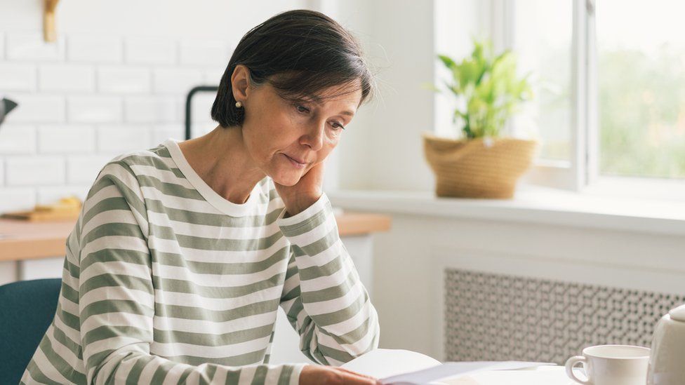 Woman looking at bills