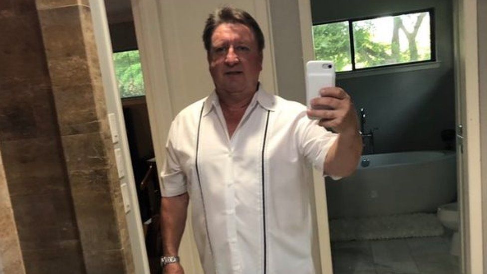 Dad takes pic wearing a white shirt