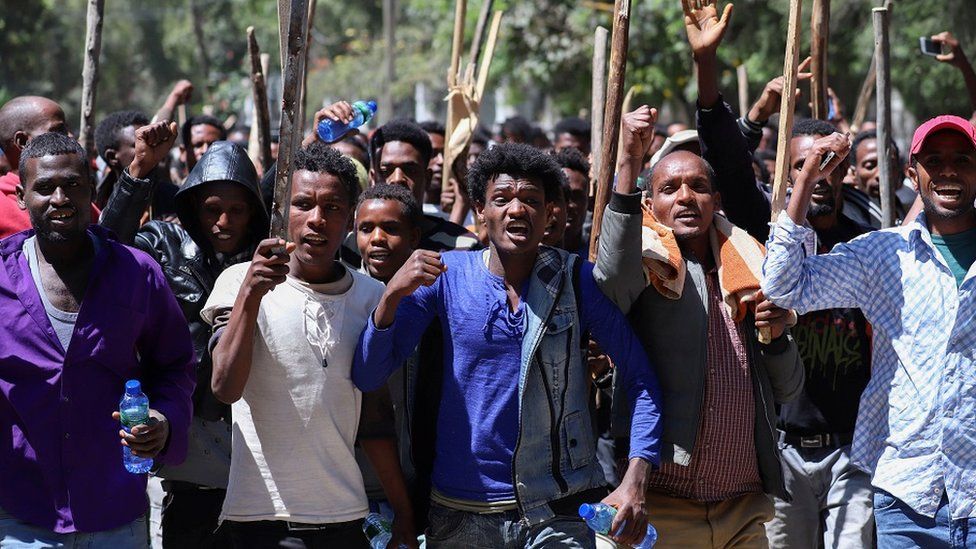 Oromo youth chant slogans during a protest in-front of Jawar MohammedÃ•s house