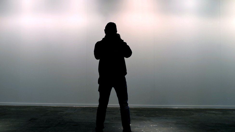 A man takes a photo of the blank space where the artwork "Presos politicos" was on display at ARCO Contemporary Art Fair, in Madrid, Spain, 21 February 2018.