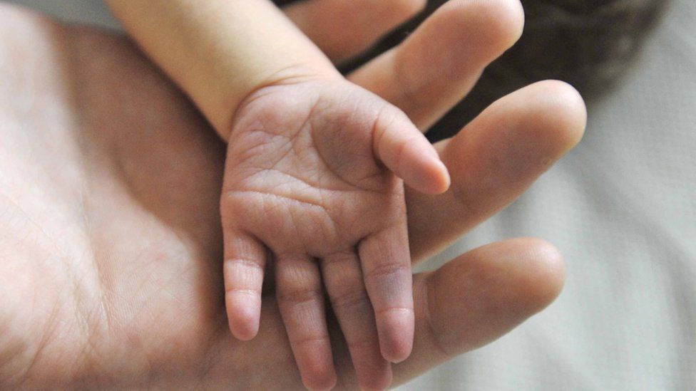 A newborn baby's hand