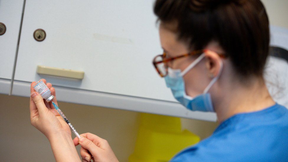 Nurse prepares Moderna vaccine