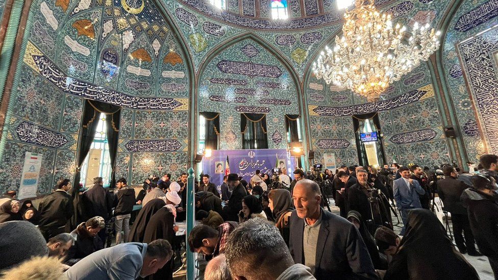 People gather to vote inside the Hosseinieh Ershad - used as a polling station in eastern Tehran