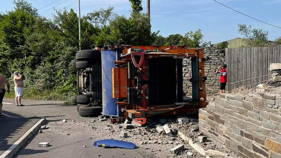 upturned bin lorry