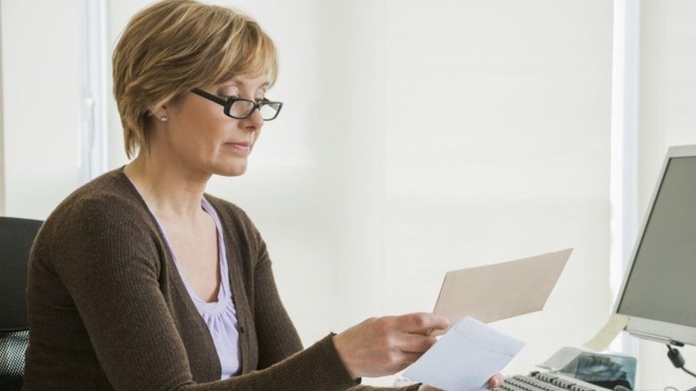 Woman looking at bills