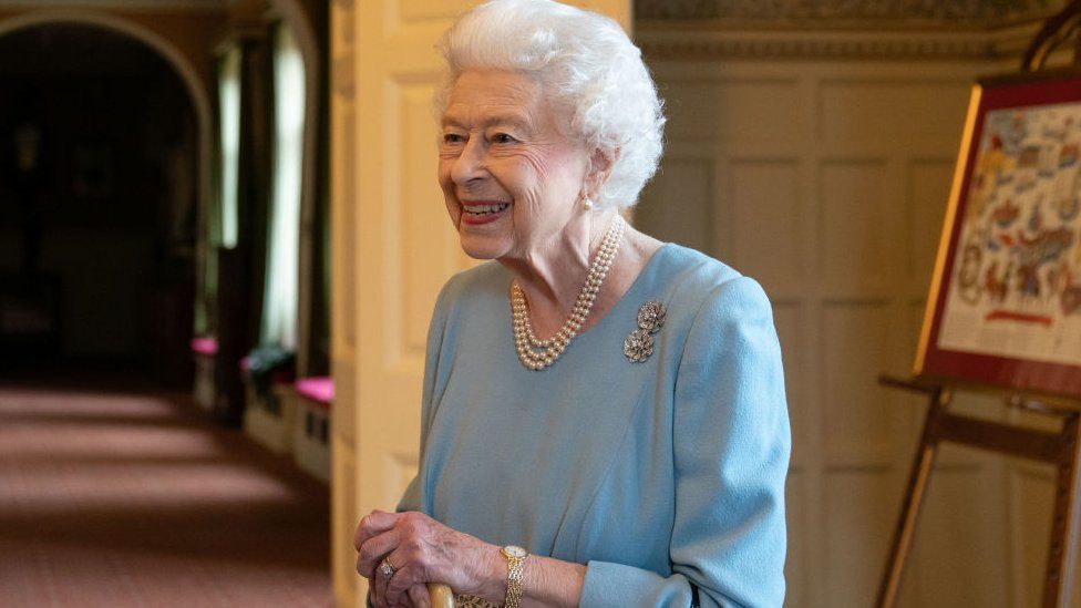 The Queen holding a walking stick on a visit on 5 February