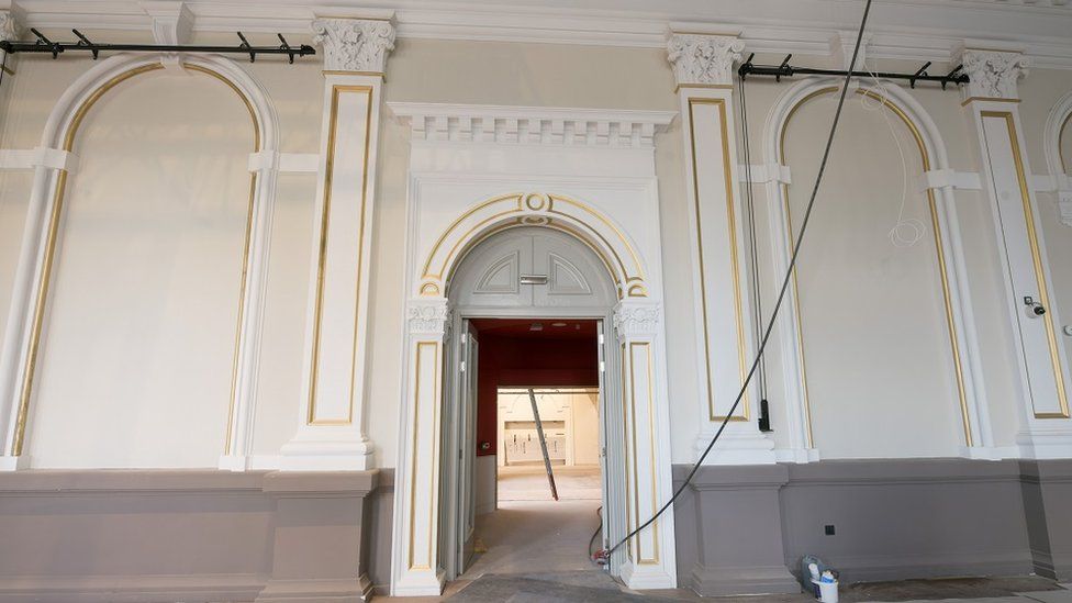 Traditional archway and wall painted white.