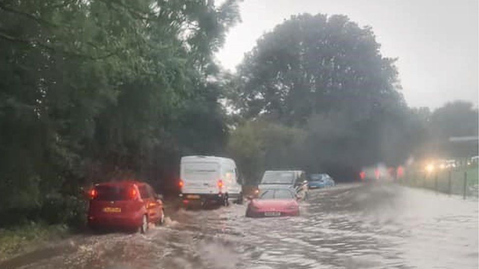 Cars in deep flood water outside -Bolingbroke arms - Hook St, Royal Wootton Bassett