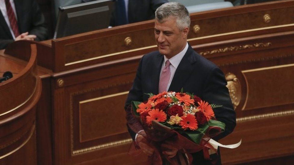 Hashim Thaci holds holds flowers after being elected Kosovo's president