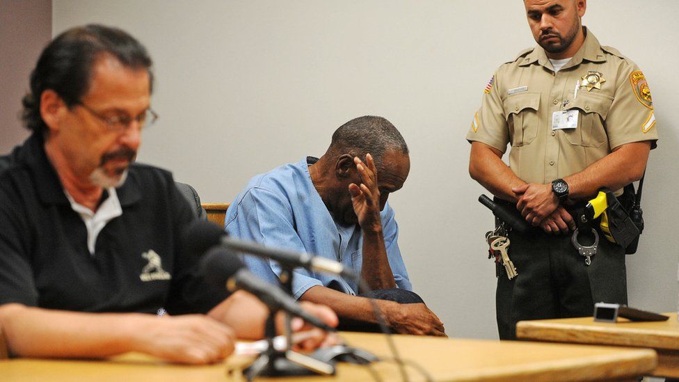 OJ Simpson (C) reacts during his parole hearing at Lovelock Correctional Centre in Lovelock, Nevada