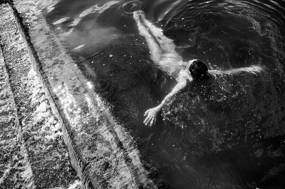 A woman floats in open water
