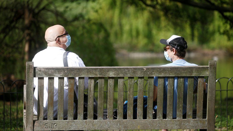 Two men wearing a protective face mask are seen in St James"s Park, as the spread of the coronavirus disease (COVID-19) continues, London,